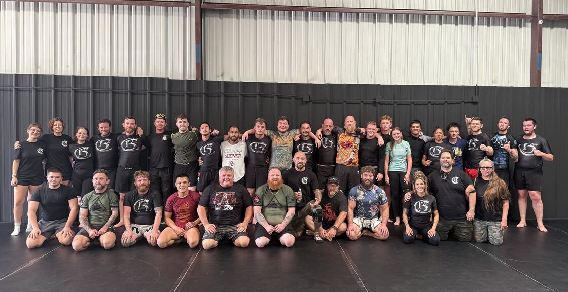 Members and coaches of 13th Chamber Fight Club gathered on the mats after training.